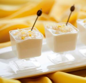 Creamy dessert cups with lemon zest garnish.
