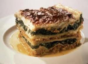 Layered dessert with cream and chocolate topping.