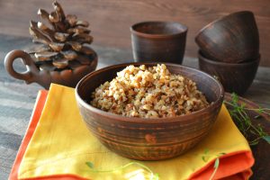 A bowl of rice on the table with two cups