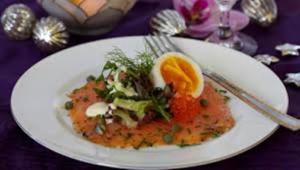 Gourmet salmon dish with egg and greens.