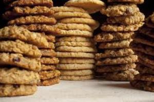 Stacks of assorted cookies on a table.