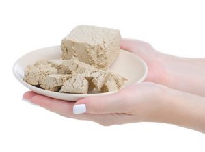 A person holding a plate with some food on it