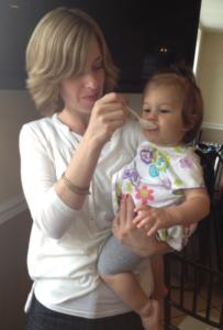 A woman holding a baby in her arms.