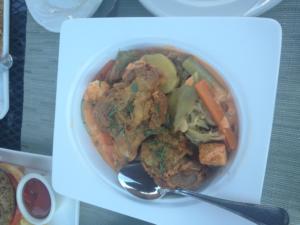 A white plate topped with food on top of a table.