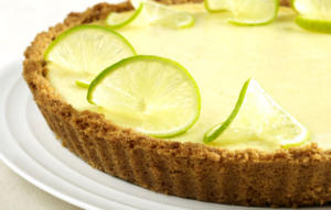 A close up of a pie with lime slices on top