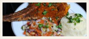 Saucy pork chop with mashed potatoes and salsa