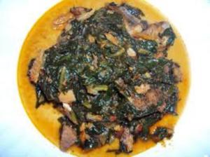 A plate of food with greens on it.