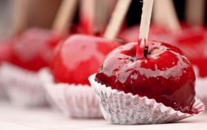 Glossy red candied apple on stick
