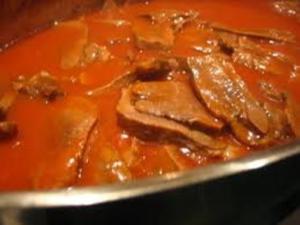 A close up of some meat in sauce