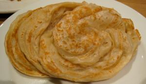 golden flaky layered flatbread on plate