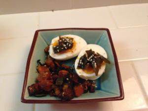 Halved eggs topped with seaweed and sesame