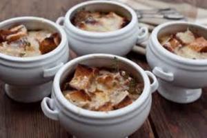 A group of four bowls with food in them.