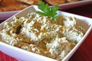 A white bowl filled with food on top of a table.