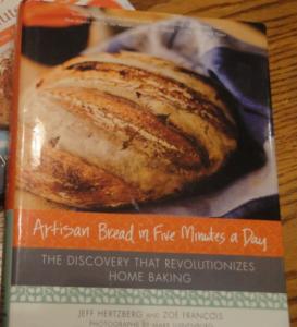 A book about bread is sitting on the table.