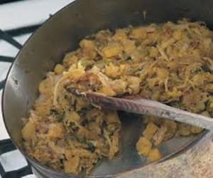 A pan of food with rice and meat in it.