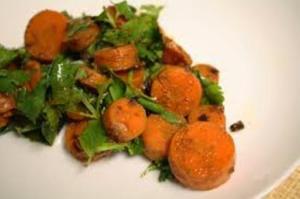 A plate of food with some carrots and greens