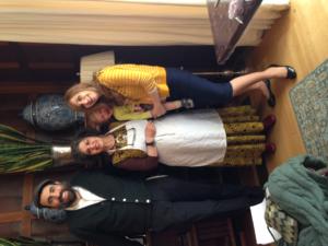 A group of people standing around in a room.