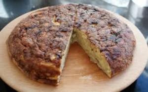 A cake sitting on top of a wooden board.