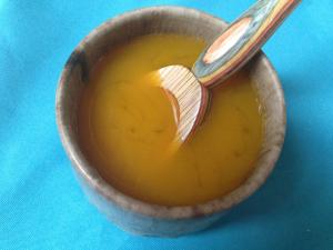 A bowl of soup with a spoon in it.