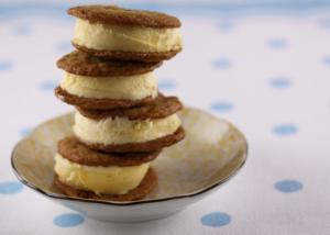 A plate with four cookies stacked on top of each other.