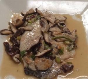 A plate of food with mushrooms and other vegetables.