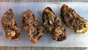 Toasted baguette slices with savory meat spread