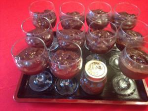A tray of jars and cups with some food in them