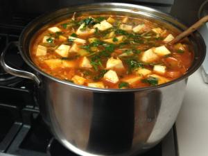 A pot of soup on the stove.