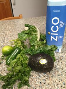 A bunch of vegetables and a bottle of zico water.