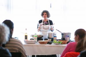 A woman sitting at the table preparing food.