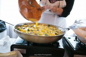 A person is cooking food on an electric stove.