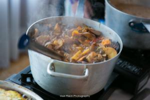 A pot of food on the stove with some meat in it.