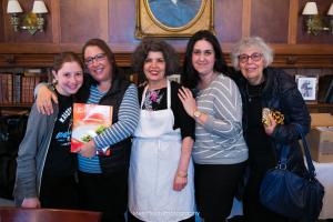 A group of people standing around each other.