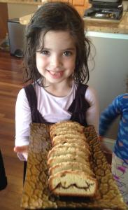 A little girl holding some food in her hands.