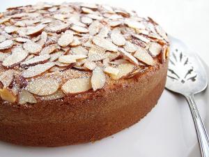 A cake with almonds on top of it.