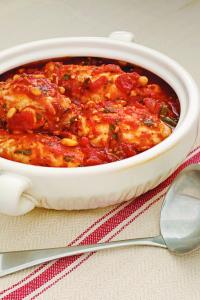 A bowl of food with some utensils on the side