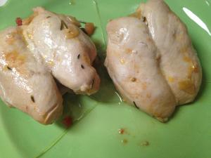 Two pieces of chicken on a green surface.