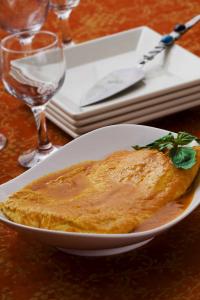 Pumpkin flan in caramel sauce, herb garnish