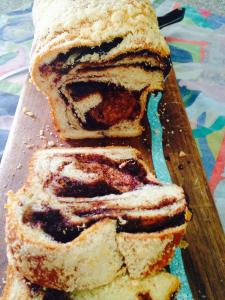 A piece of cake sitting on top of a wooden board.