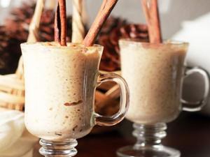 Two cups of coffee are sitting on a table.