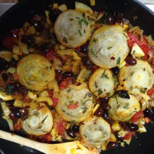 A pan of food with potatoes and vegetables.