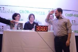 A man standing in front of two women.