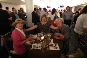 A group of people sitting around a table with wine glasses.