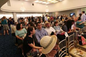 A crowd of people sitting in a room.