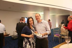 Two guests smiling with drinks at reception