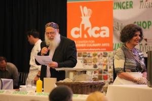 A man in an orange suit and white beard.