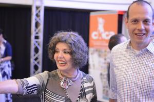 A woman in a gray and white striped sweater.