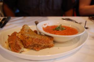 A plate of food with bread and tomato soup.