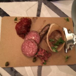 A cutting board with meat and vegetables on it.