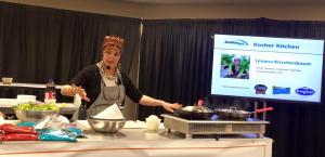 A woman in an apron is cooking food.
